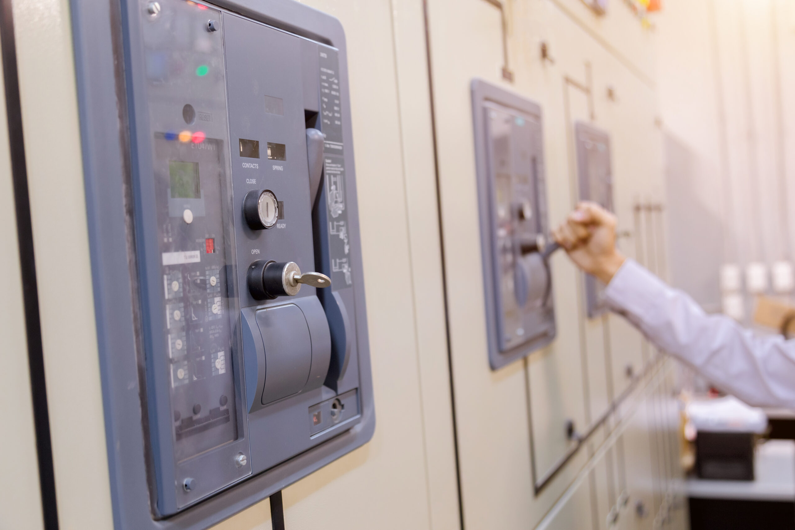 Engineer inspecting switchgear control panel